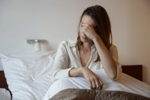 Woman sits in bed and wishes she knew some tips for morning anxiety